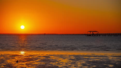 Time-lapse-orange-sunrise-big-sun-over-sea-water-sand-beach-relaxing-exotic-place