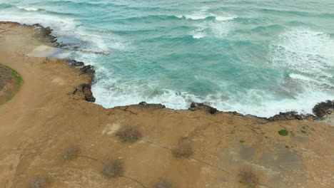 Waves-of-sea-crashing-against-rocky-coastline-in-Paralimni,Cyprus