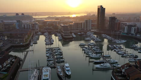 Aerial-panning-over-boat-harbour-Ocean-Village-Southampton-during-sunset-4K