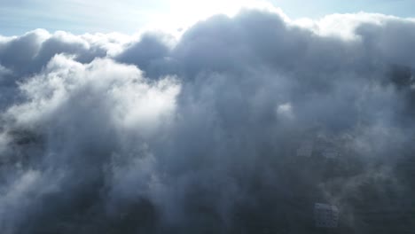 Aerial-flying-towards-and-passing-through-cloud,-Abha,-Saudi-Arabia
