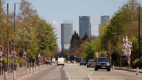 Springtime-view-of-Castlefield,-Manchester-with-blooming-trees-and-modern-buildings,-clear-day,-timelapse