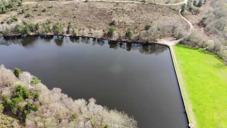 Flying-Over-Calm-Squabmoor-Reservoir-Located-In-Woodbury-Common