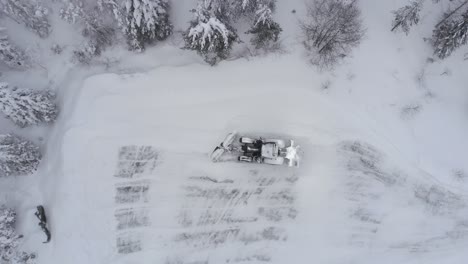 Above-View-Of-A-Tractor-Removing-Thick-Snow-On-The-Field