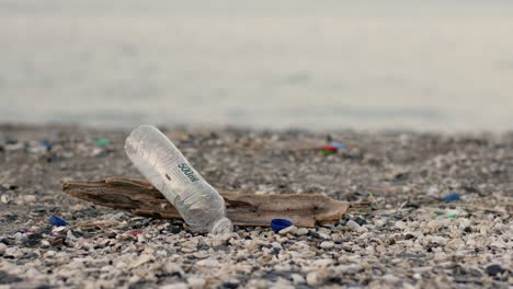 Empty-bottle-thrown-on-khasab-beach,-image-of-environmental-pollution