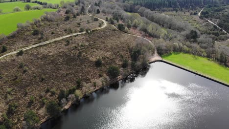 Aerial-View-Of-Woodbury-Common-Beside-Squabmoor-Reservoir-On-Sunny-Day