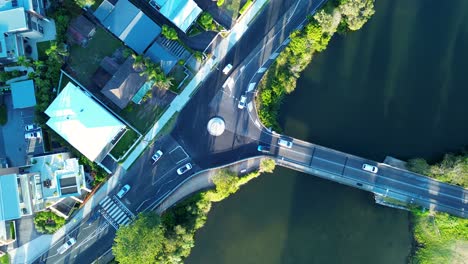 Drone-aerial-cars-driving-around-roundabout-transport-Terrigal-bridge-lagoon-infrastructure-traffic-Erina-Central-Coast-Australia