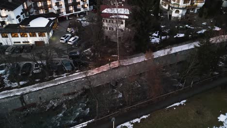 River-canal-in-township-of-Kirchberg-in-Austria,-aerial-drone-view