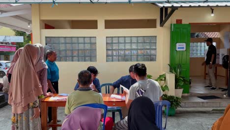 People-registering-during-Indonesian-presidential-election,-outdoor-daytime-setting