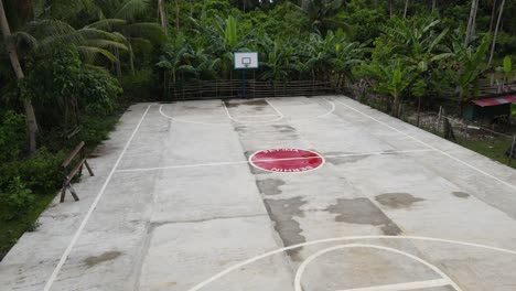 Aerial-Drone-Fly-Above-Basketball-court-around-Green-Jungle-in-Phillipines