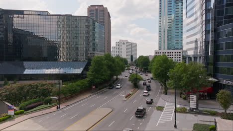 Aerial-view-of-cars-on-road-in-american-city-with-skyscraper-buildings