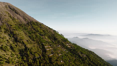 Drone-shot-of-shanty-houses-near-summit-of-inactive-Acatenango-volcano-in-Guatemala-during-sunrise