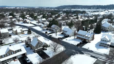Aerial-descent-into-neighborhood-with-snow