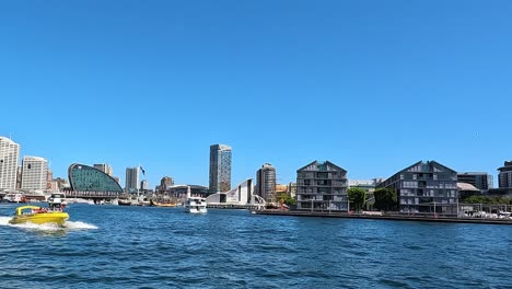 View-of-Darling-Harbour-entrance-Sydney-with-Jet-boat-and-transport-NSW-ferry-leaving-Barangaroo-point-jetty