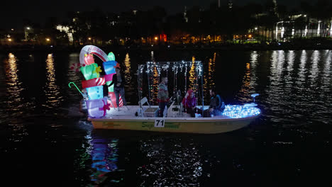 People-Navigating-On-Lighted-Boat-Parade-By-Night-In-Christmas,-Tampa-Florida