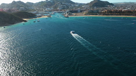 Aerial-view-approaching-ferry-arriving-in-Cabo-San-Lucas,-sunny-day-in-Mexico