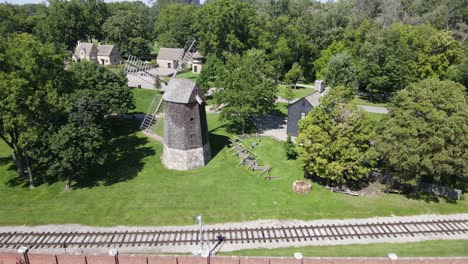 Farris-Windmill-in-historic-Greenfield-Village,-Dearborn,-Michigan,-USA,-aerial-truck-left-view