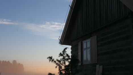 sunrise-with-morning-steam-dolly-time-lapse-rustic-old-wooden-house