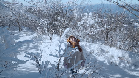 Lovely-Toddler-Girl-Explorer-Standing-at-Mountain-Trail-in-Winter-Looking-Up-Into-Sky-in-Snow-Covered-Balwangsan-Mountain-Top-Mona-Park---slow-motion,-Gangwon-do,-South-Korea