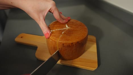 Female-hands-cutting-cheese-to-extract-one-piece,-4K