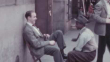 Man-in-a-Suit-Sitting-while-Polishing-His-Shoes-in-New-York-City-in-1930s