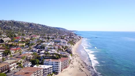 Breathtaking-4K-Aerial-View-of-Laguna-Beach-and-the-Pacific-Ocean-through-the-Coastline-with-Beachfront-Properties-on-a-Warm,-Sunny-Day