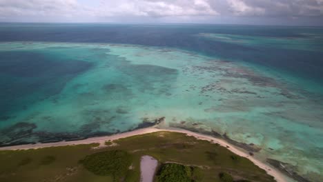 Aerial-view-ocean,-Beautiful-tropical-coral-reef-and-coastline,-Los-Roques-Archipelago-pan-right