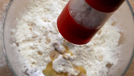 grinding-salt-in-dough-close-up-slow-motion