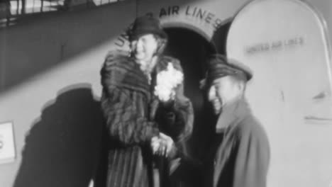 Elegant-Woman-Greets-American-Airlines-Employee-at-Airplane-Door-in-1930s