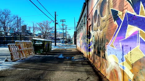 Graffiti-covered-alleyway-in-Denver's-RiNo-art-district-on-a-bright-sunny-winter-day