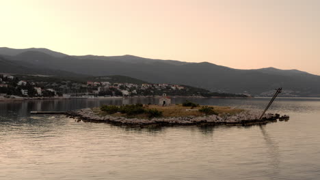 Low-angle-panoramic-view-of-the-Sveti-Marin-Chapel-on-a-small-deserted-island-near-the-coastline-of-Novi-Vinodolski