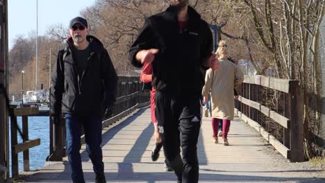 People-walk-and-exercise-by-water-in-Stockholm-during-corona-times