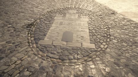 drawing-of-castle-on-stone,-on-the-ground,-Cobblestone-art,-Medina-Sidonia,-Cádiz-Spain