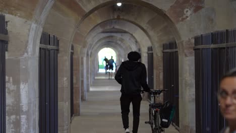 Cyclist-Carries-His-Bicycle-Inside-Barrage-Vauban-in-Strasbourg