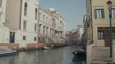 Tranquil-Venice-canal-scene-with-moored-boats,-Italy