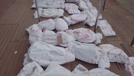 Close-up-of-mock-dead-bodies-outside-the-Scotland-BBC-Headquarters