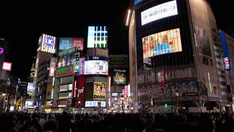 Cinematic-POV-shot-walking-across-Shibuya-Crossing-with-people-silhouettes