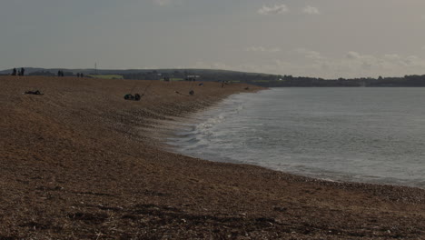 extra-wide-shot-of-fishermen-at-Hurst-spit-looking-with-the-Isle-of-Wight-in-background