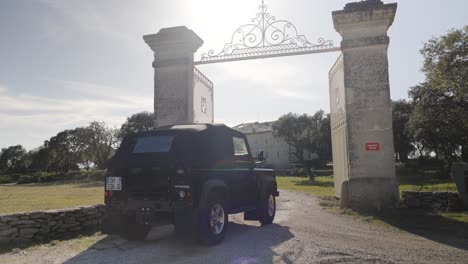 SUV-Fährt-Durch-Traditionelles-Steinsäulentor,-Pic-St.-Loup,-Frankreich