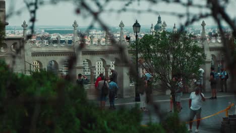 Slow-Motion-Rack-Focus-Between-Branches-of-Tourists-Visiting-Budapest