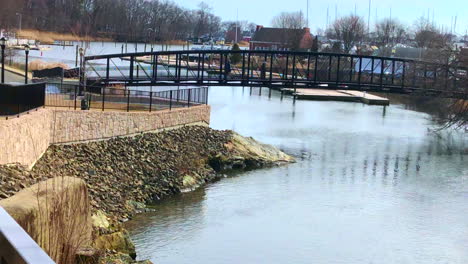 Wide-Angle-4-K-Editorial-left-pan-footage-of-people-walking-on-an-iron-bridge