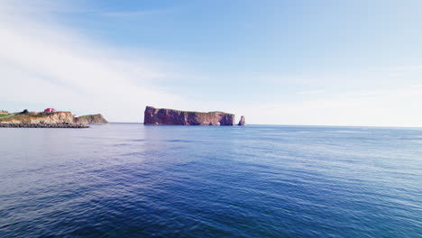 Drone-view-receding-from-Percé-Rock-during-a-sunny-day