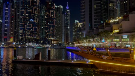 DUBAI,-UAE--04-January-2024:-Tilt-shot-og-Night-view-of-Dhow-and-skyscrapers-in-Dubai-Marina---a-residential-neighborhood-and-a-district-in-Dubai,-United-Arab-Emirates