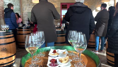 Busy-winery-tasting-room-with-guests-and-snacks