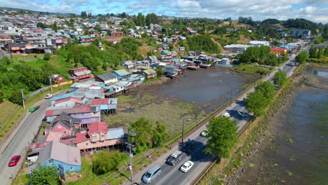 Bird's-eye-view-of-an-isolated-place-of-palafitos-without-water-in-Castro-Chiloe-on-a-sunny-day,-low-tide,-tourist-model-to-visit-in-Chile