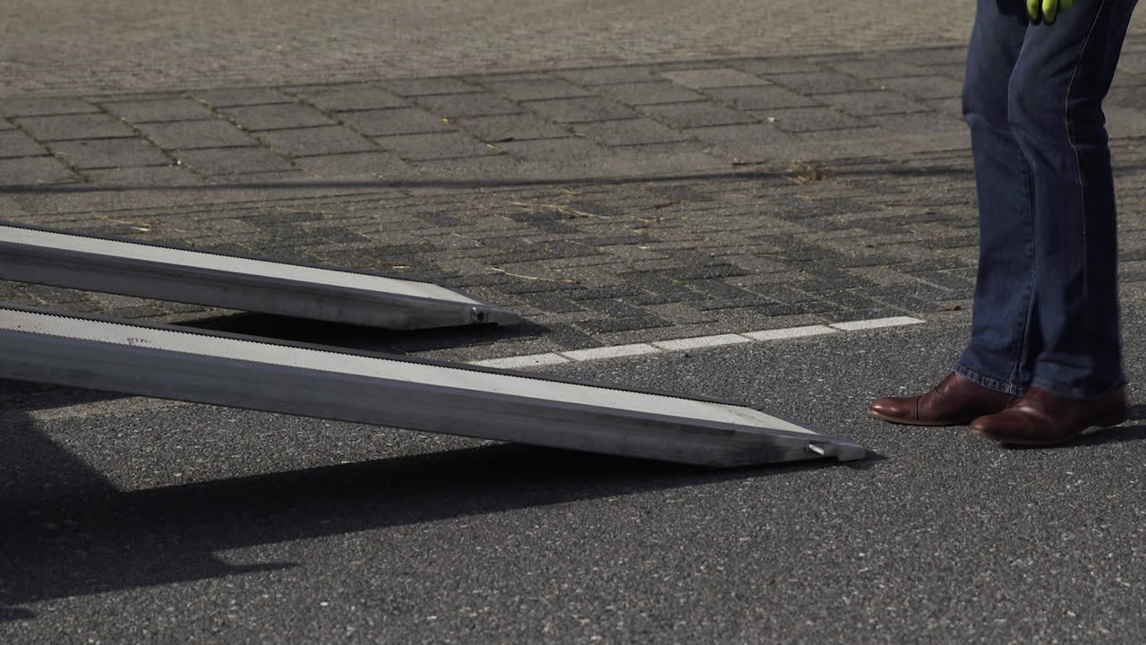 Corporate Car Salesman Wearing Suit Pulling Out Metal Ramp From Car ...
