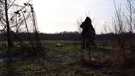 Dark-silhouette-of-woman-walk-with-baby-carriage-on-countryside-field