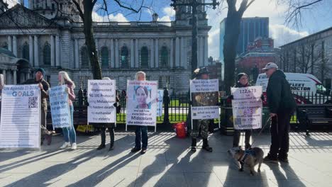 A-static-shot-of-People-holding-placards-against-Gaza-invasion-by-Isreal-with-long-shadows