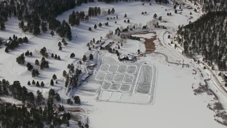 Winter-Etown-Evergreen-Lake-house-traffic-fishing-tents-Denver-golf-course-Colorado-aerial-drone-Ice-skating-skate-hockey-rink-pond-hockey-sunset-golden-hour-winter-snow-forward-circle-left-birds-eye