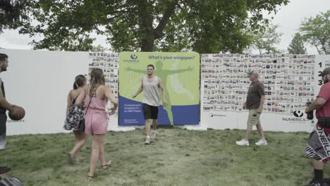 Hoopfest-2018---people-measuring-themselves-against-sign-of-basketball-player