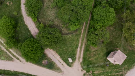 Overhead-drone-shot-moving-up-over-the-village-of-Tsarichina-Hole,-a-remote-neighborhood-in-Bulgaria-known-for-some-paranormal-activities